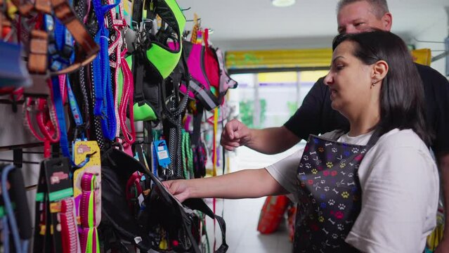 Pet Shop owner helping male customer to buy Dog Products inside Local Store