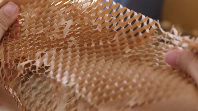 Eco vendor go green packaging parcel carton box in net zero waste store asian seller retail shop. Earth care day small SME owner asia people wrap reuse brown paper pack gift reduce plastic free order.