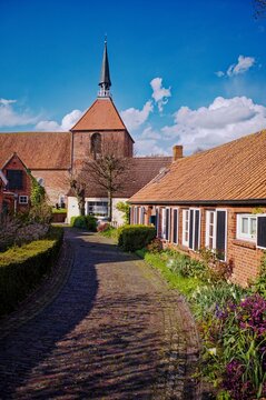 Villagescape and local church, Rysum, Krummhorn, East Frisia, Lower Saxony, Germany