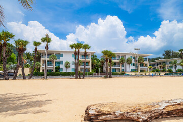 five-star hotel on the shores of Karon Beach with palm trees and yellow creaky sand