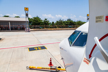 close-up on the nose of a passenger plane with windows at the airport in thailand. travel and cargo transportation.