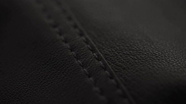 Slow motion handheld shot of soft gray brown leather closeup