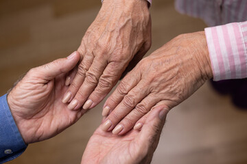 Fototapeta premium Close up view of mature couple holding hands. Love, care, support, empathy and understanding in marriage. Getting older together concept