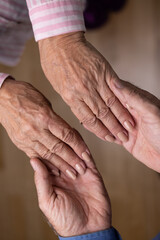 Close up view of mature couple holding hands. Love, care, support, empathy and understanding in marriage. Getting older together concept - 602110565