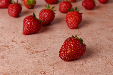 Close up of fresh strawberries on red marble table