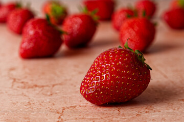 Close up of fresh strawberries on red marble table