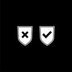 Shield check and x icon  isolated on black background 