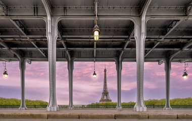 Eifell Tower at sunrise from Pont Bir De Hakeim Bridge Paris France. Looking through the bridge and accross at the Eiffel Tower