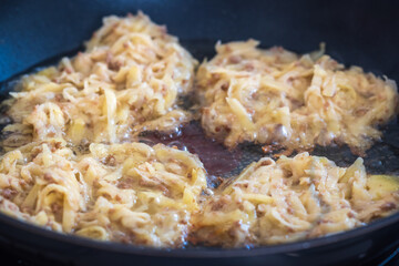 Potatoe pancakes flapjacks frying inside pan