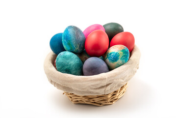 Multi colors Easter eggs in the woven basket isolated on white background with clipping path