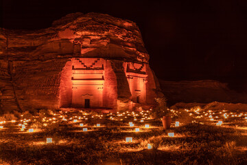 Ancient tombs of Hegra city illuminated during the night, Al Ula, Saudi Arabia