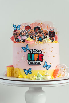 KYIV, UKRAINE - April 01: Birthday cake for a little fan of Toca Life World video game. Pink cake for a girl on the white background
