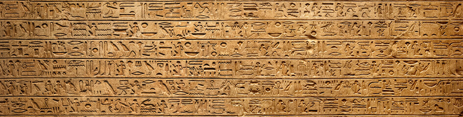 Fototapeta Old Egyptian hieroglyphs on an ancient background. Wide historical background. Ancient Egyptian hieroglyphs as a symbol of the history of the Earth. obraz