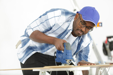 a man cutting wood block with fretsaw