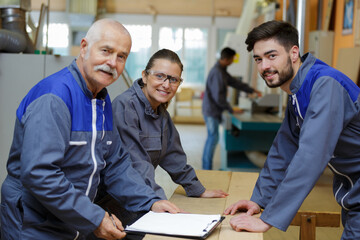 group of woodworker posing and smiling