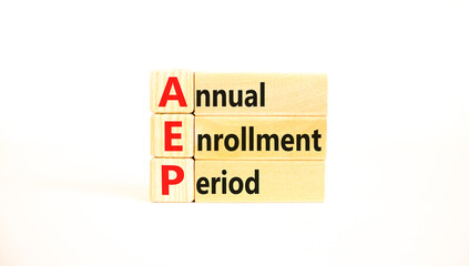 AEP symbol. Concept words AEP Annual enrollment period on beautiful wooden block. Beautiful white table white background. Medical and AEP Annual enrollment period concept. Copy space.