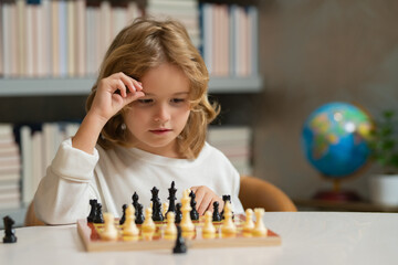 Kid thinking of chess. Little child play chess. Kid playing board game. Thinking child brainstorming and idea in chess game. Chess school and education. Logic game for kids and logical thinking.