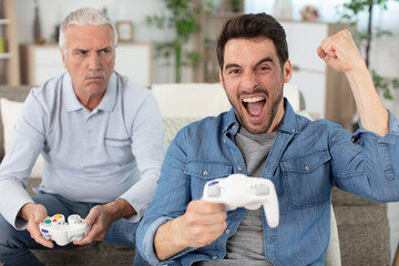 father and son playing video games © auremar