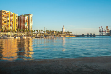 Port of Malaga Muelle Uno with Lighthouse (La Farola) at sunset - Malaga, Andalusia, Spain