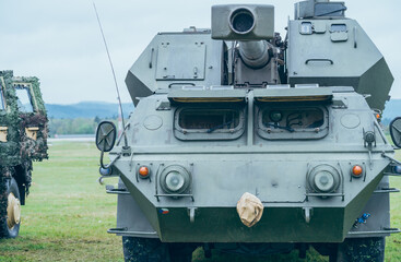 Fototapeta premium Military vehicles. Combat howitzer. Modern military vehicle with cannon. Armored army vehicle