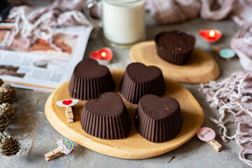 Dessert for children. Breakfast for lovers: glazed cottage cheese in the shape of a heart. Cottage cheese in chocolate. Gray background. Close-up