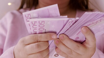 closeup female hands count paper 500 euro banknotes on beautiful blurred creamy background with bokeh, payments to fund, gift for holiday, social assistance poor, save up for vacation, car, winnings