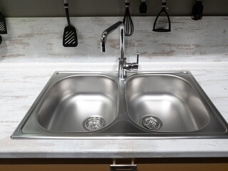 Two sinks and a faucet in the kitchen