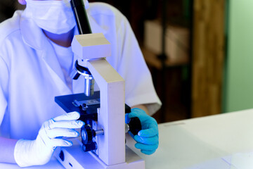 The scientist biologist is working very seriously use microscope