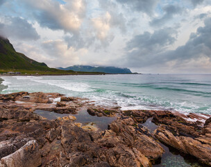 Summer cloudy view of the stony beach in Ramberg (Norway, Lofoten). People unrecognizable.