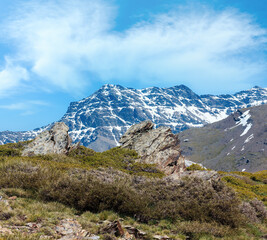 Fototapeta na wymiar Summer mountain landscape with snow on slope (Sierra Nevada National Park, near Granada, Spain).