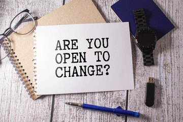 are you open to change. two notepads with text. near bright stationery.
