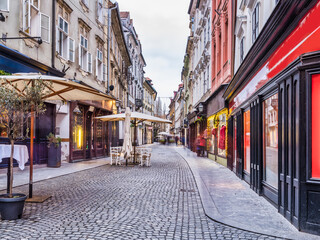 Fototapeta premium Cobblestone street and tourist shops during Christmas in Ljubljana old town, Slovenia