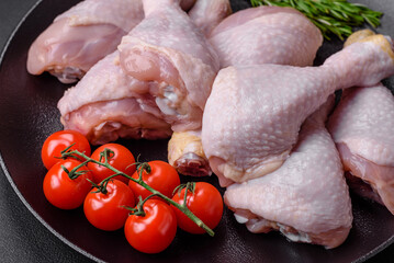 Raw chicken legs with salt, spices and herbs