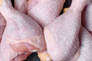 Raw chicken legs with salt, spices and herbs