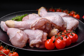 Raw chicken legs with salt, spices and herbs