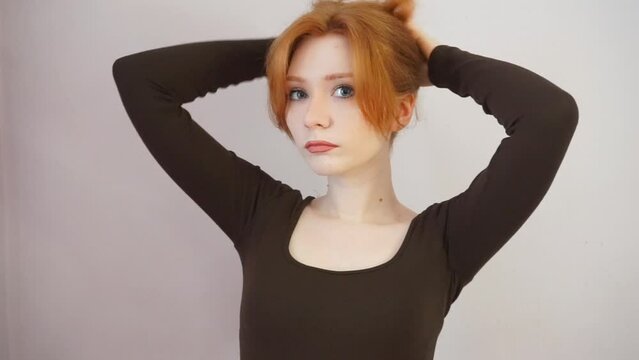 redhead girl doing her hair, sad woman, freckled ginger, long wavy hair, melancholy, playing with hair, hairstyle