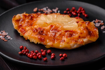 Grilled chicken fillet in the form of a steak with tomatoes, pineapple and cheese