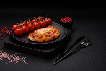 Grilled chicken fillet in the form of a steak with tomatoes, pineapple and cheese