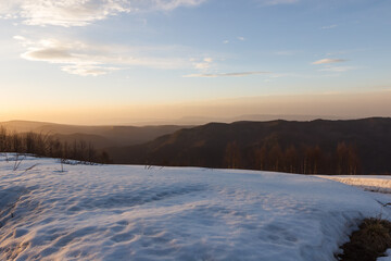 Fototapeta na wymiar Sunset with a view of the snow-capped mountain peaks of Arkhyz near the BTA
