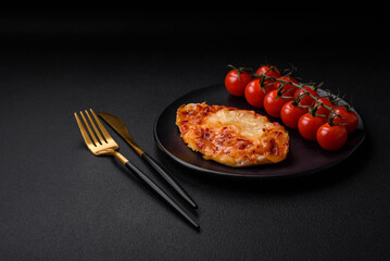 Grilled chicken fillet in the form of a steak with tomatoes, pineapple and cheese