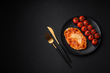 Grilled chicken fillet in the form of a steak with tomatoes, pineapple and cheese