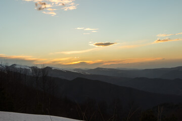 Sunset with a view of the snow-capped mountain peaks of Arkhyz near the BTA