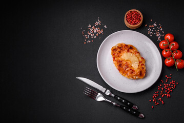 Grilled chicken fillet in the form of a steak with tomatoes, pineapple and cheese