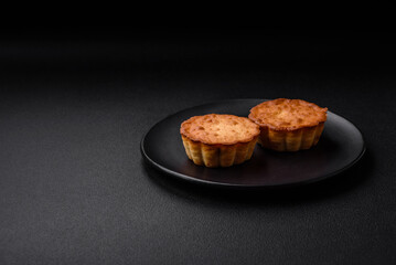 Delicious baked cupcake or tartlet with cheese and raisins