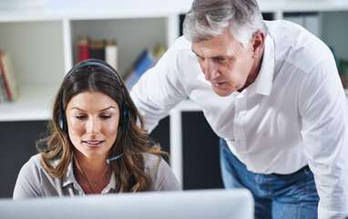 Mentor, woman or senior manager in call center training telemarketing in customer services office. Contact us, coaching or mature leader teaching an insurance agent on new job advice on computer