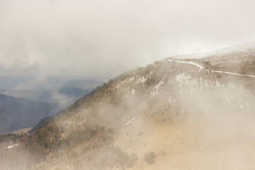 Ascent to Pastukhova Mountain on Arkhyz. Snow-capped mountains with low clouds