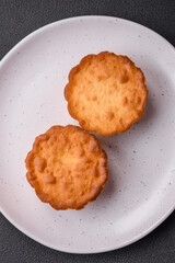 Delicious baked cupcake or tartlet with cheese and raisins