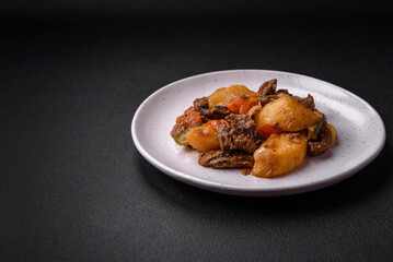Delicious stew with potatoes, tomatoes, beef, onions and carrots