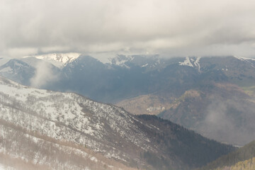 Ascent to Pastukhova Mountain on Arkhyz. Snow-capped mountains with low clouds