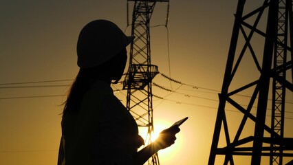 Electrical Engineer. engineer work tablet sunset. towers electricity work. work digital helmets....